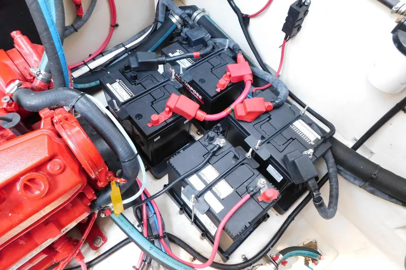 Slide: The Image of Engine compartment of a 2005 Sea Ray 320 Sundancer with batteries and wiring. - 124