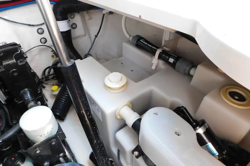 Slide: The Image of Engine compartment of a 2005 Sea Ray 320 Sundancer boat, showing mechanical components. - 128
