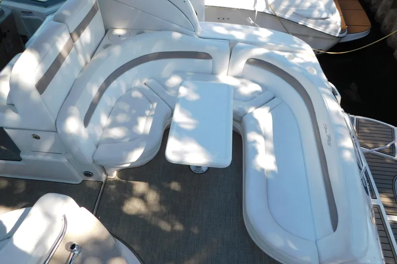 Slide: The Image of 2005 Sea Ray 320 Sundancer boat interior with white seating and table. - 18