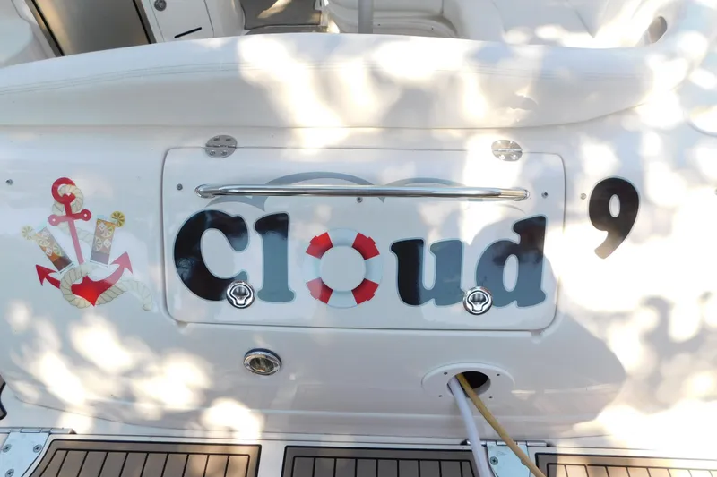 Slide: The Image of 2005 Sea Ray 320 Sundancer boat with "Cloud 9" name and anchor design on the stern. - 20