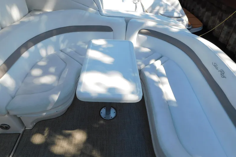 Slide: The Image of 2005 Sea Ray 320 Sundancer interior with white seating and table. - 25