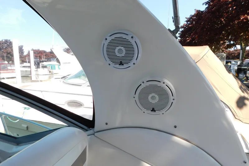 Slide: The Image of 2005 Sea Ray 320 Sundancer boat speakers, docked with other boats in the background. - 26