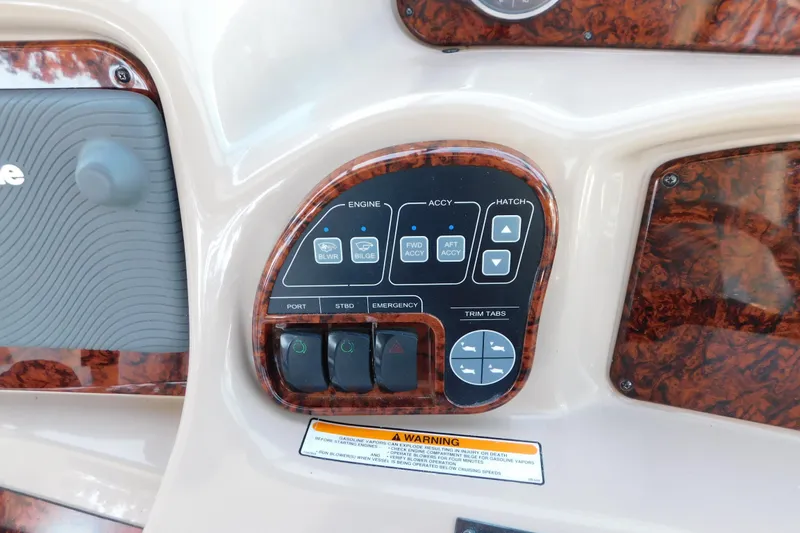 Slide: The Image of Control panel of a 2005 Sea Ray 320 Sundancer boat with various switches and buttons. - 33