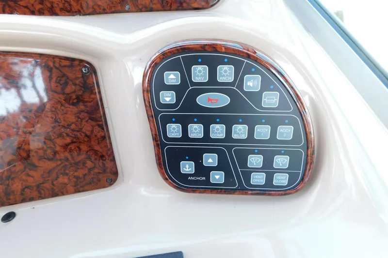 Slide: The Image of Control panel of 2005 Sea Ray 320 Sundancer boat with various function buttons. - 34