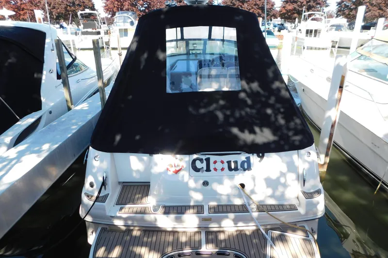 Slide: The Image of 2005 Sea Ray 320 Sundancer docked with black cover, rear view. - 4