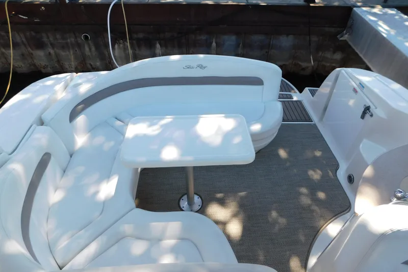 Slide: The Image of 2005 Sea Ray 320 Sundancer boat interior with white seating and table. - 42