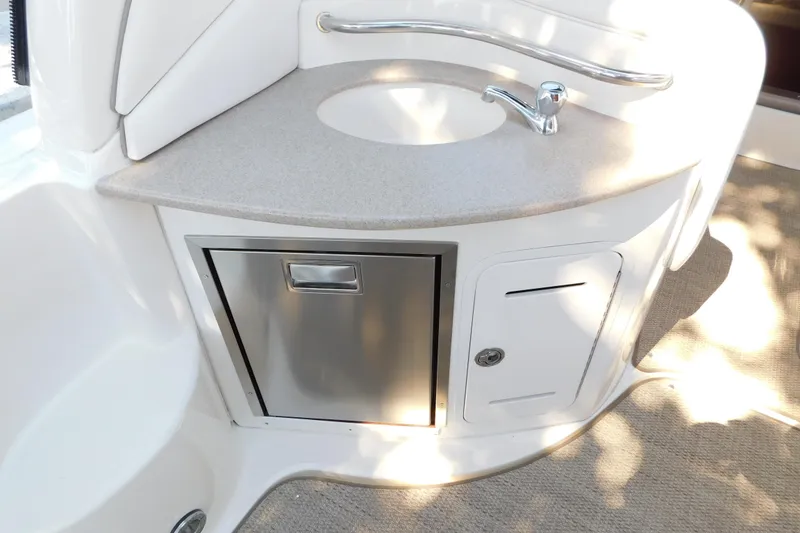 Slide: The Image of 2005 Sea Ray 320 Sundancer boat kitchenette with sink and storage compartments. - 43