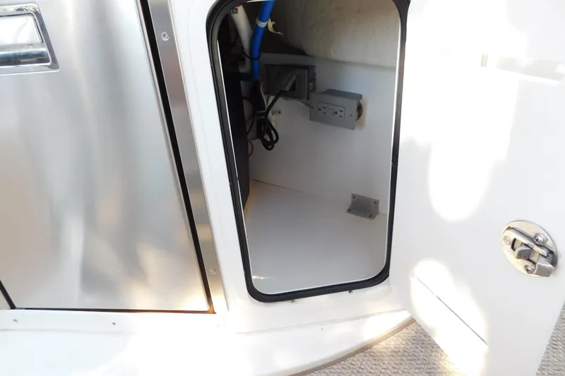 Slide: The Image of Open storage compartment on 2005 Sea Ray 320 Sundancer boat, showing interior details. - 45