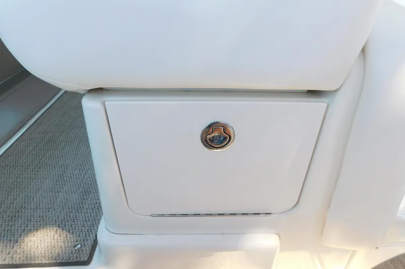 Slide: The Image of 2005 Sea Ray 320 Sundancer interior storage compartment with sleek design and chrome handle. - 46