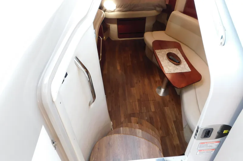 Slide: The Image of Interior of 2005 Sea Ray 320 Sundancer with wood flooring and cozy seating area. - 48