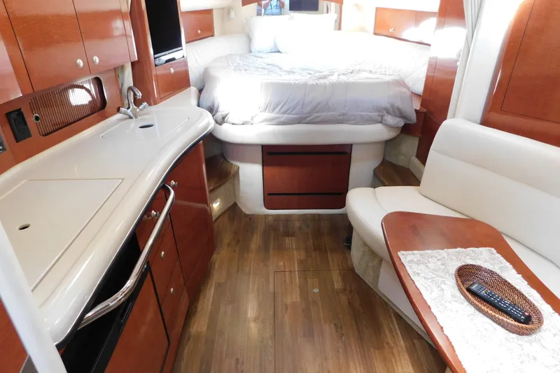 Slide: The Image of Luxurious interior of 2005 Sea Ray 320 Sundancer yacht with cozy bed and kitchenette. - 50