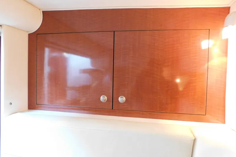 Slide: The Image of Wooden cabinet interior of 2005 Sea Ray 320 Sundancer yacht, featuring sleek design and modern finish. - 55