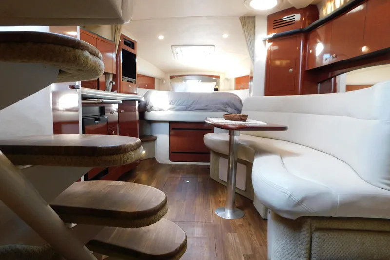 Slide: The Image of 2005 Sea Ray 320 Sundancer interior with elegant seating, wooden flooring, and modern amenities. - 58