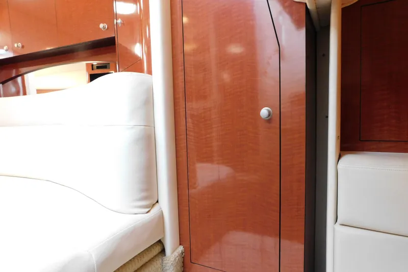 Slide: The Image of Interior of 2005 Sea Ray 320 Sundancer with polished wood and white upholstery. - 59