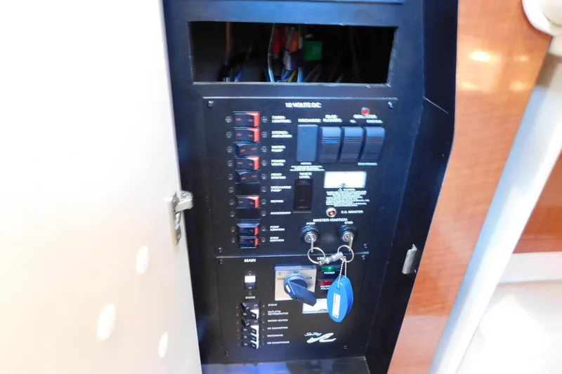 Slide: The Image of Electrical panel of a 2005 Sea Ray 320 Sundancer boat with switches and keys. - 61