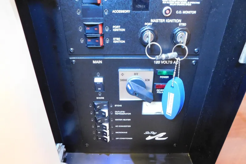 Slide: The Image of Control panel of a 2005 Sea Ray 320 Sundancer boat with ignition keys and switches. - 63