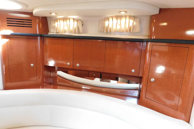 Slide: The Image of Luxurious interior of 2005 Sea Ray 320 Sundancer with polished wood cabinetry. - 64