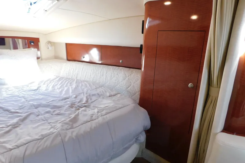 Slide: The Image of Luxurious cabin interior of 2005 Sea Ray 320 Sundancer with cozy bedding and wood finish. - 70