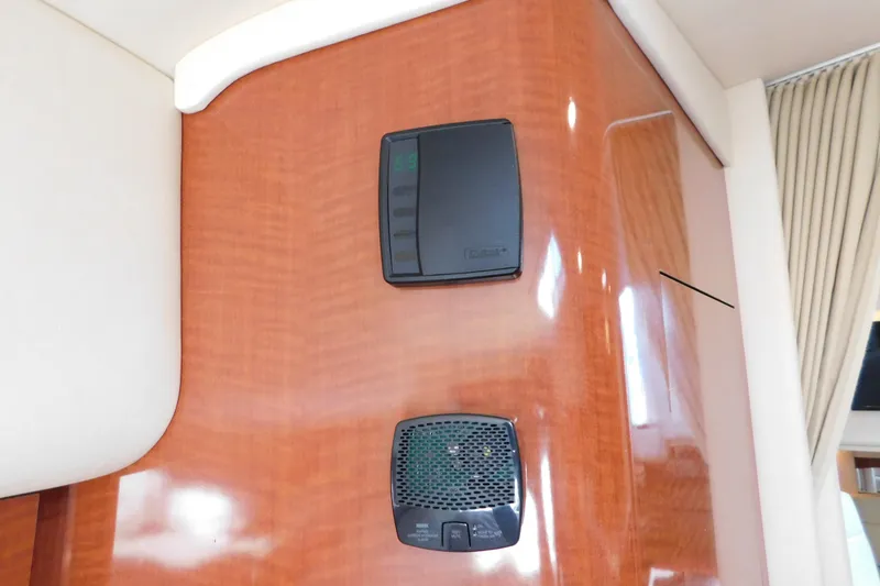 Slide: The Image of Control panel on 2005 Sea Ray 320 Sundancer's polished wooden interior. - 72