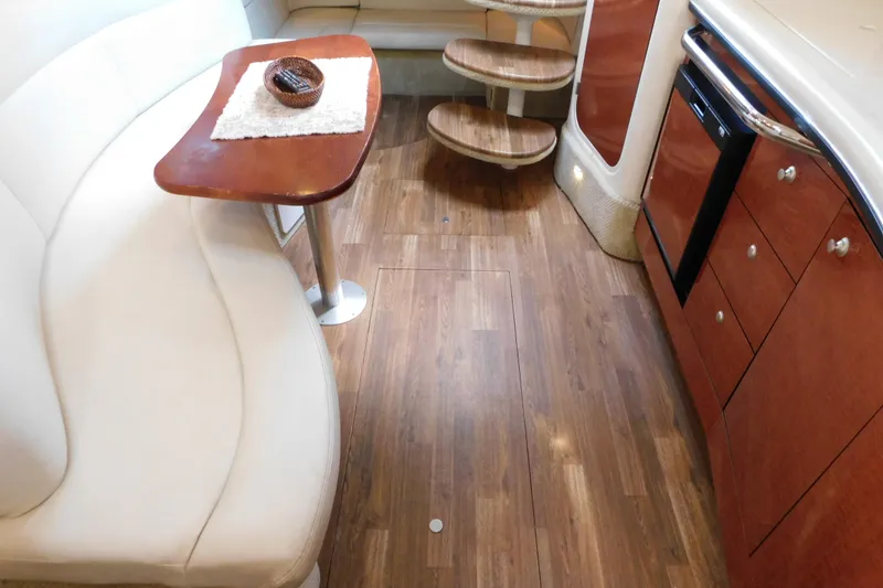 Slide: The Image of Interior of 2005 Sea Ray 320 Sundancer with wood flooring and elegant seating area. - 74