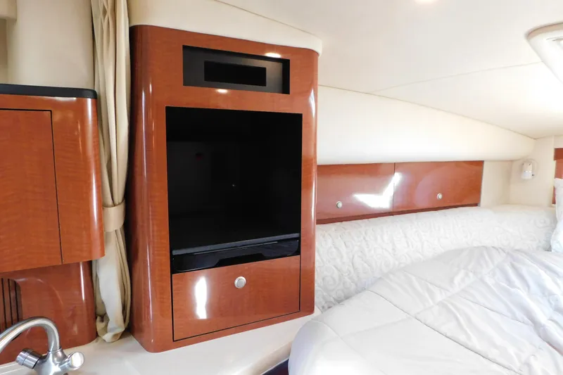 Slide: The Image of Interior of 2005 Sea Ray 320 Sundancer with wood cabinetry and cozy bedding. - 78
