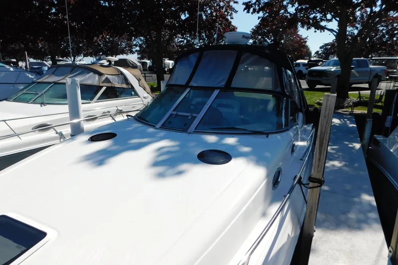 Slide: The Image of 2005 Sea Ray 320 Sundancer docked, featuring sleek design and spacious deck. - 8