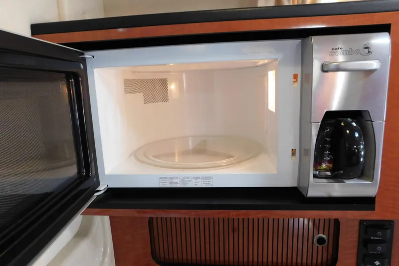 Slide: The Image of Microwave and coffee maker in 2005 Sea Ray 320 Sundancer yacht kitchen. - 86