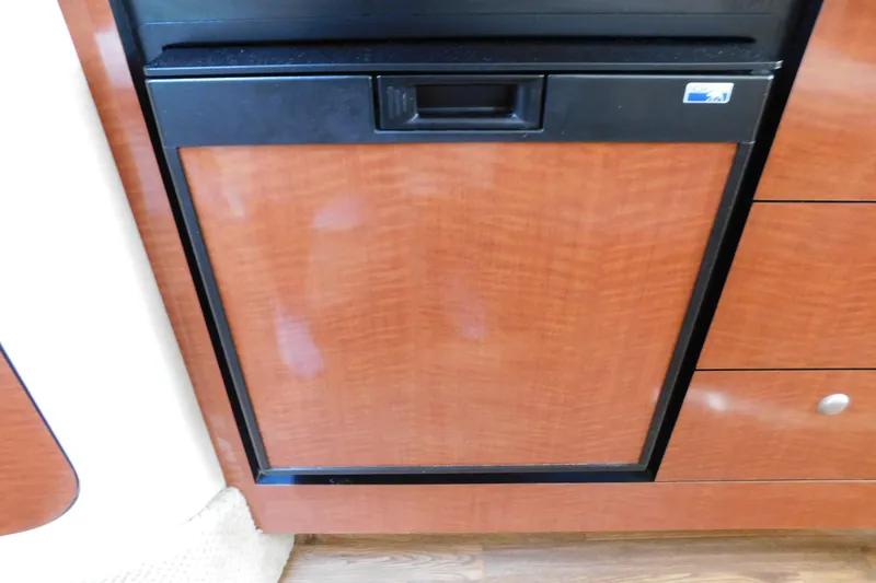 Slide: The Image of Wood-paneled refrigerator in 2005 Sea Ray 320 Sundancer yacht interior. - 87