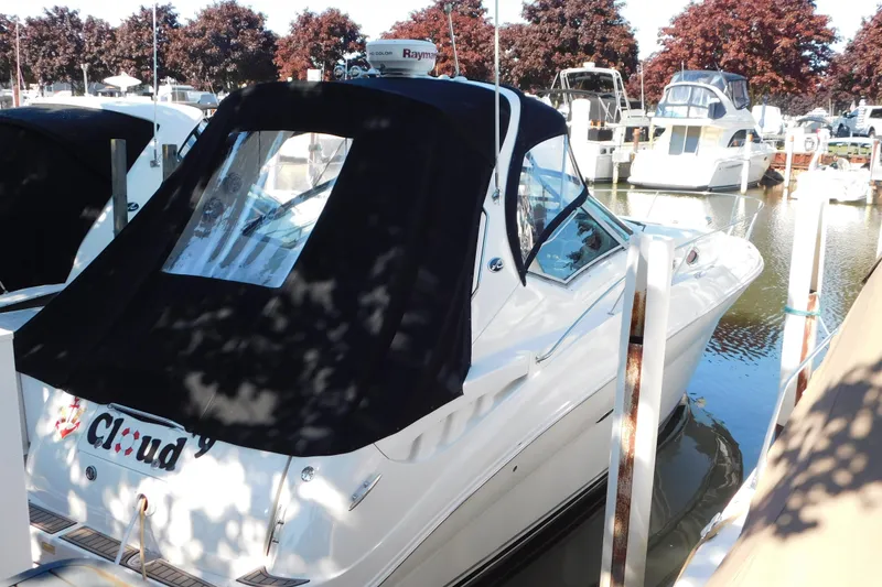 Slide: The Image of 2005 Sea Ray 320 Sundancer docked at marina with black canopy. - 9