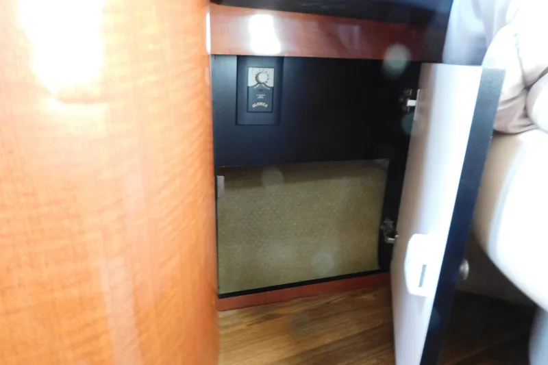 Slide: The Image of Open cabinet in 2005 Sea Ray 320 Sundancer boat interior, showing storage space. - 90