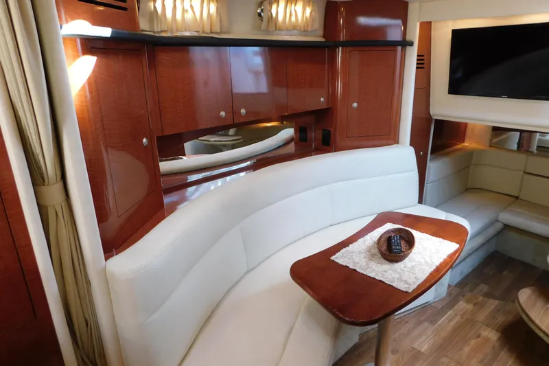 Slide: The Image of Luxurious 2005 Sea Ray 320 Sundancer interior with elegant seating and wooden cabinetry. - 91