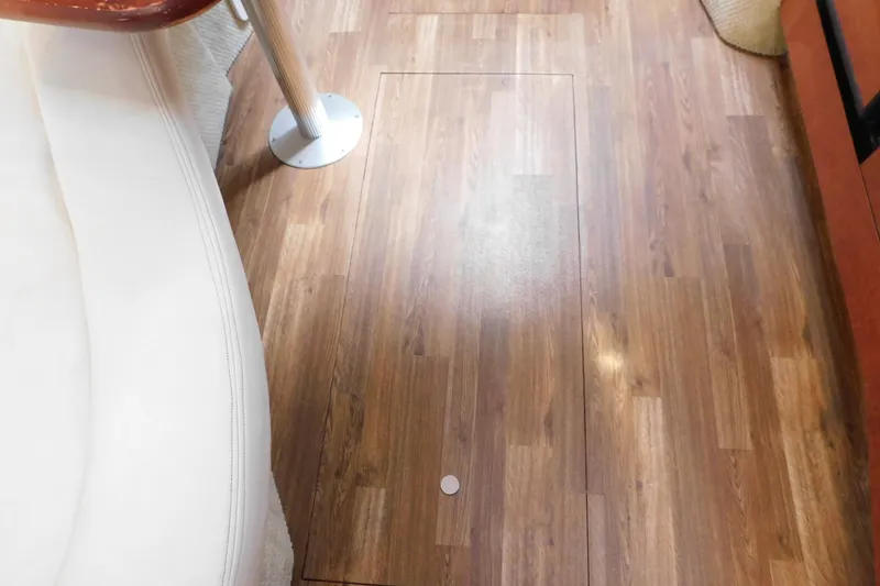 Slide: The Image of Interior view of 2005 Sea Ray 320 Sundancer with wood flooring and white seating. - 94