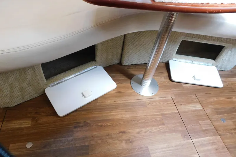 Slide: The Image of 2005 Sea Ray 320 Sundancer interior with storage compartments and wooden flooring. - 99