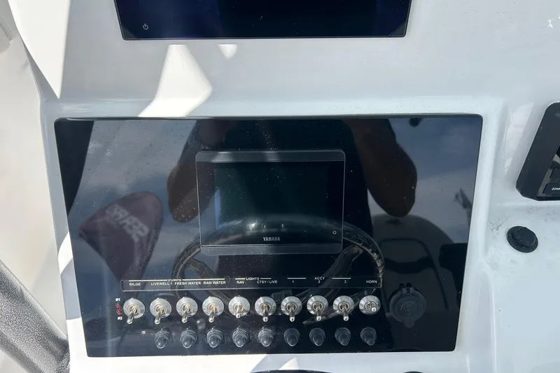 Slide: The Image of Control panel of 2026 Sea Pro 222 Center Console boat with switches and display. - 15