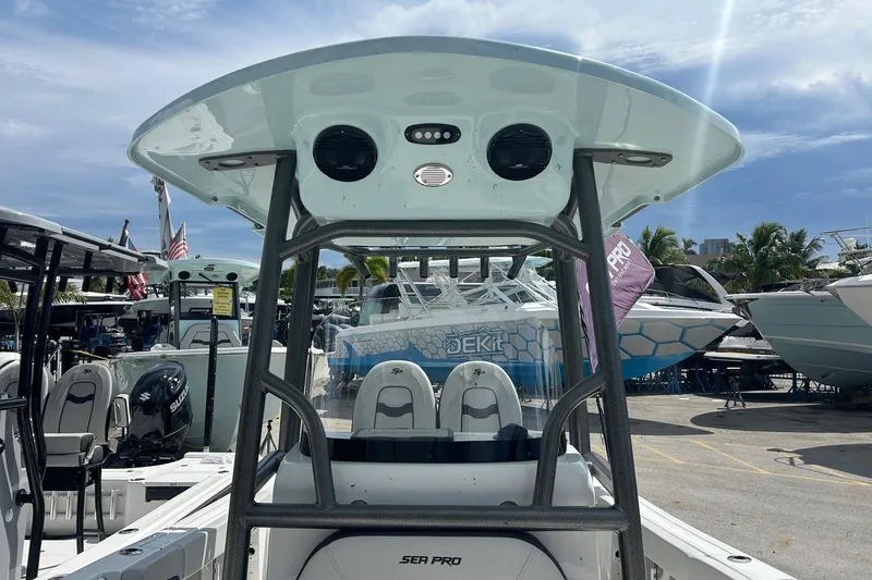 Slide: The Image of 2026 Sea Pro 222 Center Console boat at a marina under a sunny sky. - 29