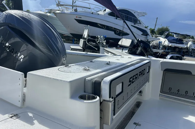 Slide: The Image of 2026 Sea Pro 222 Center Console boat with Yamaha engine, docked in marina. - 30