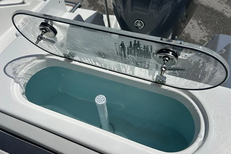 Slide: The Image of Livewell on 2026 Sea Pro 222 Center Console boat, open lid with water inside. - 37