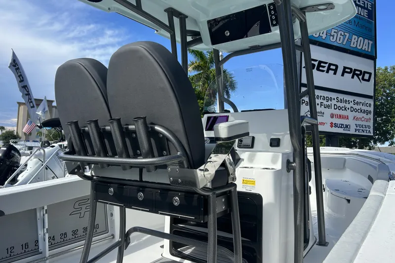 Slide: The Image of 2026 Sea Pro 222 Center Console boat interior with dual seats and rod holders. - 4