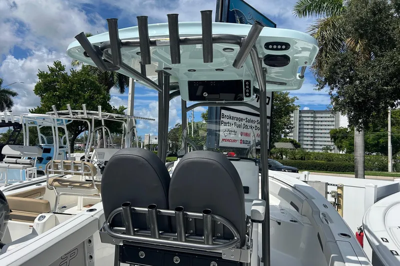 Slide: The Image of 2026 Sea Pro 222 Center Console boat with rod holders, parked outdoors. - 7