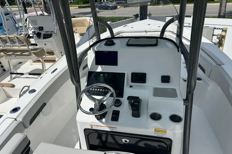 Slide: The Image of 2026 Sea Pro 222 Center Console boat interior with steering wheel and control panel. - 8