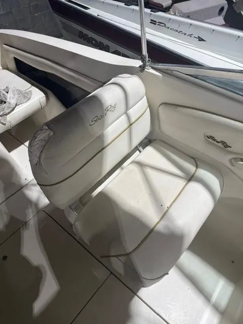 Slide: The Image of 1999 Sea Ray 215 Express Cruiser interior with white seating. - 11