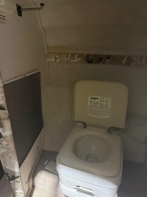 Slide: The Image of 1999 Sea Ray 215 Express Cruiser interior with portable toilet. - 14