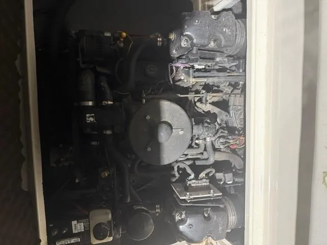 Slide: The Image of Engine compartment of a 1999 Sea Ray 215 Express Cruiser boat. - 16