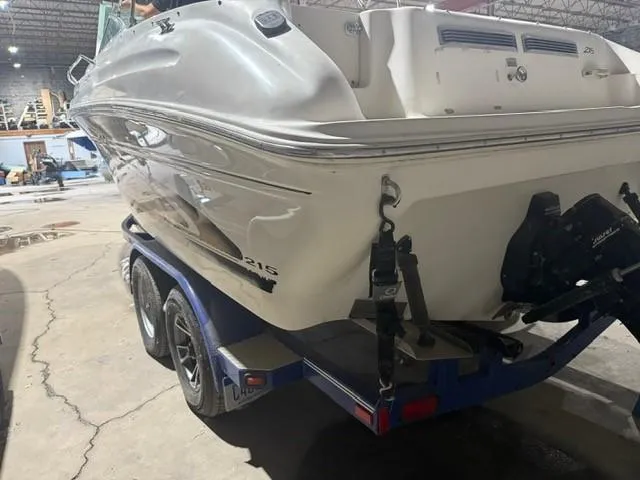 Slide: The Image of 1999 Sea Ray 215 Express Cruiser on trailer in indoor storage facility. - 5