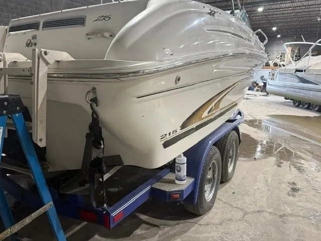 Slide: The Image of 1999 Sea Ray 215 Express Cruiser on trailer in indoor storage facility. - 6
