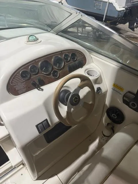 Slide: The Image of 1999 Sea Ray 215 Express Cruiser dashboard with steering wheel and instrument panel. - 8