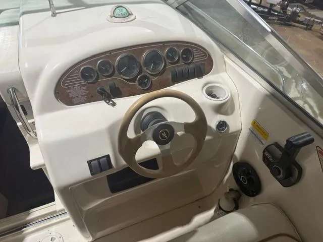 Slide: The Image of 1999 Sea Ray 215 Express Cruiser dashboard with steering wheel and instrument panel. - 9