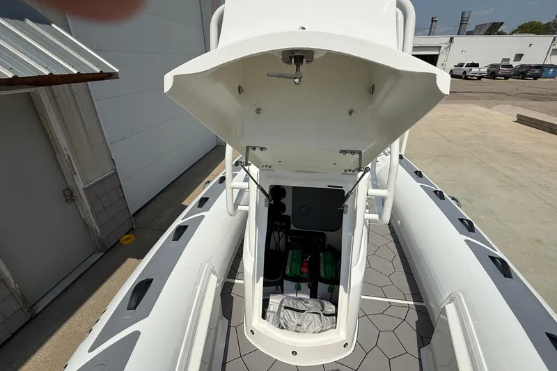 Slide: The Image of 2025 Highfield Sport 560 boat with open storage compartment, showcasing interior equipment. - 11