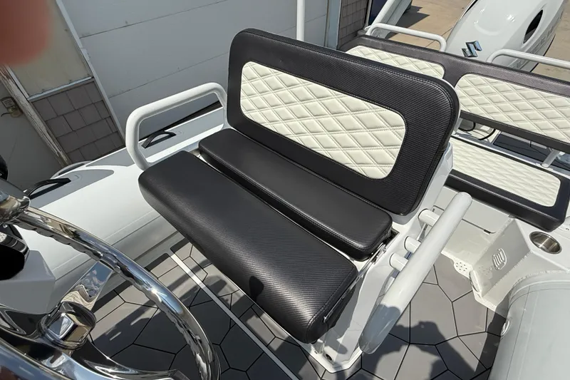 Slide: The Image of 2025 Highfield Sport 560 boat seat with black and white diamond-patterned upholstery. - 16