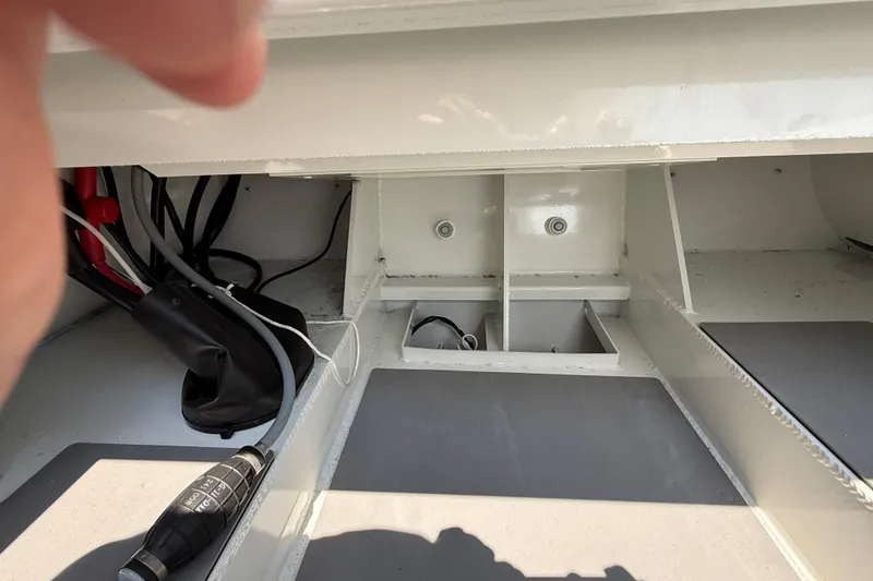 Slide: The Image of Interior view of a 2025 Highfield Sport 560 boat, showcasing wiring and compartments. - 22